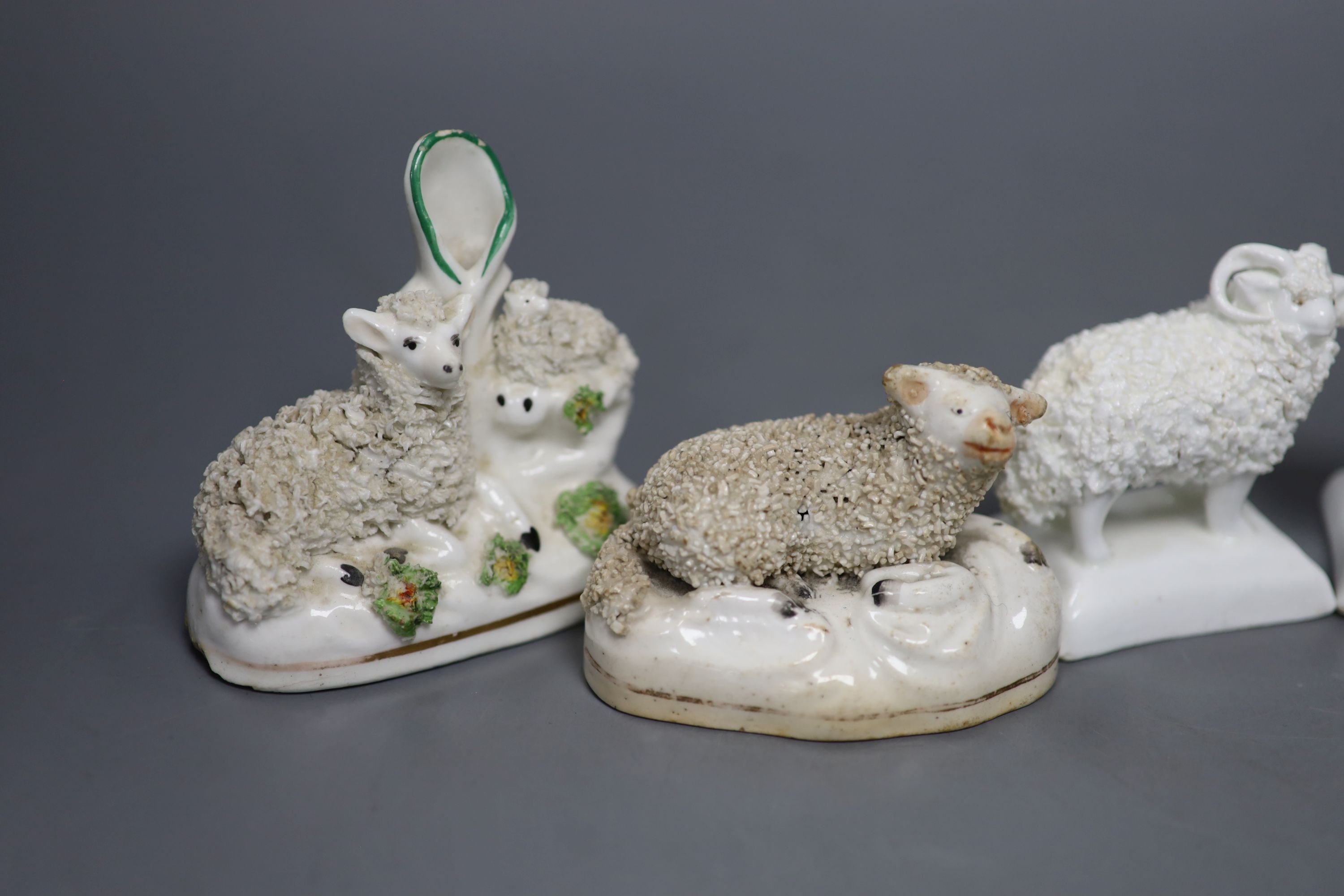 Two pairs of Staffordshire porcelain figures of sheep and two similar ‘sheep’ spill vases, c.1830-50, tallest 8.5 cm